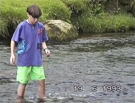 Eliot Thomas-Wright retrieves the frisbee from the river near Bellever